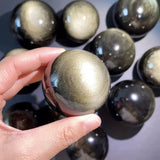 Gold obsidian sphere